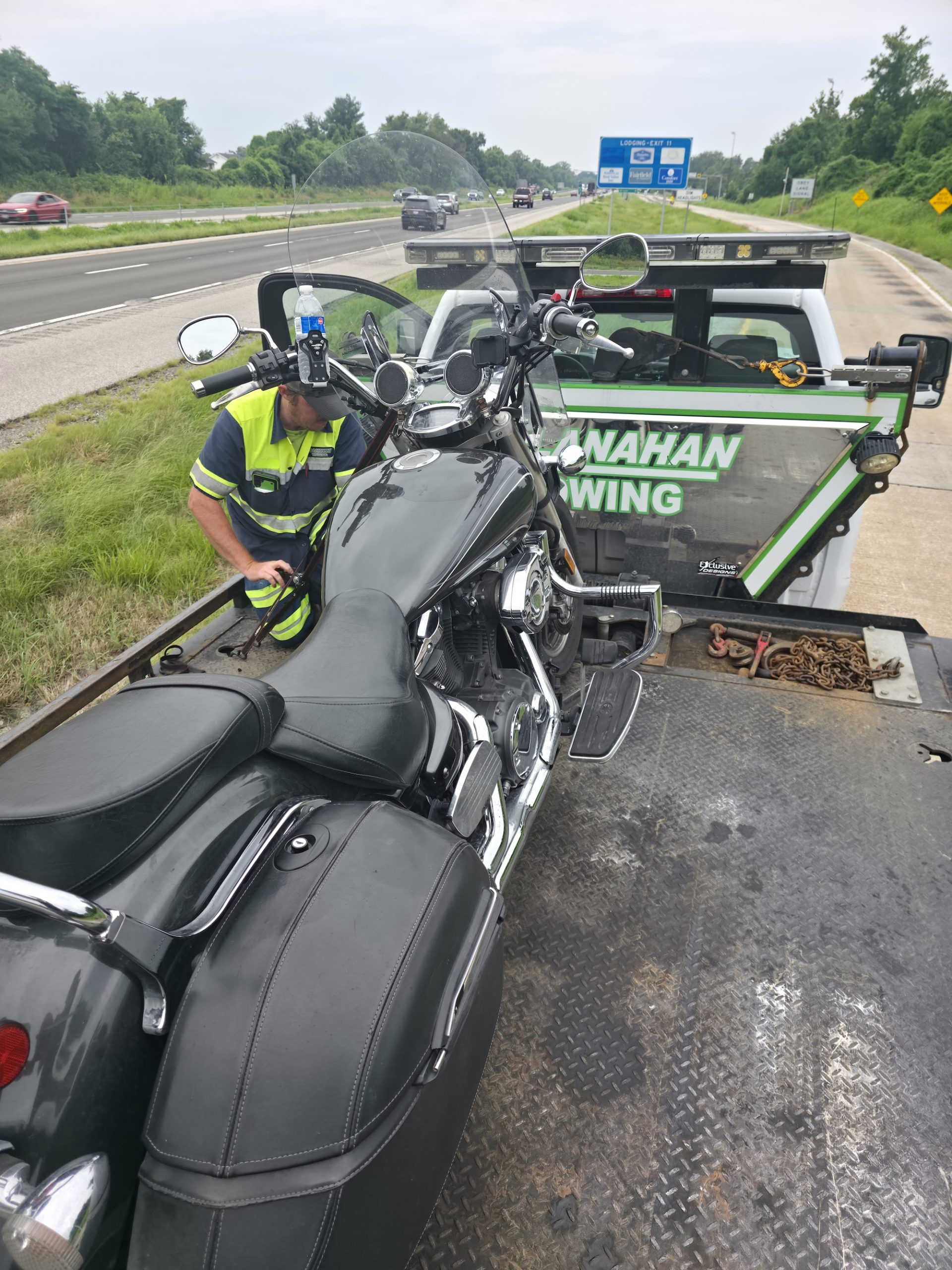 A motorcycle loaded onto a flatbed trailer after a breakdown — the kind of setback that turns the goal into simply showing up on hard days.