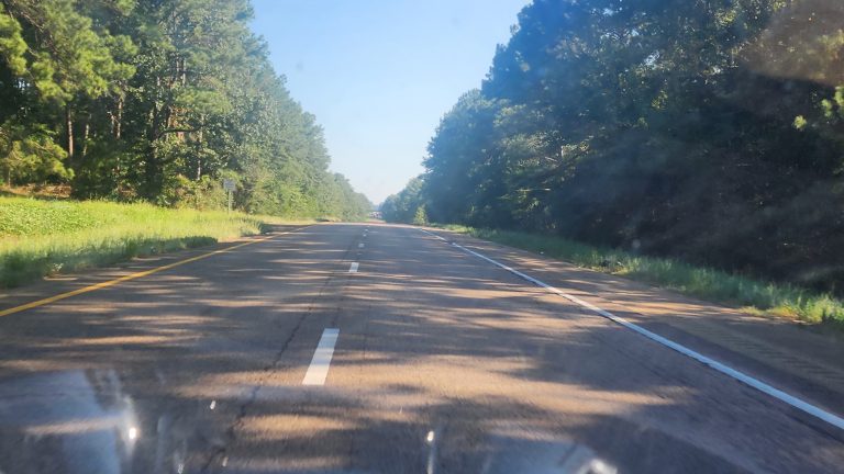 Open highway through the Mississippi Delta during solo travel preparation ride