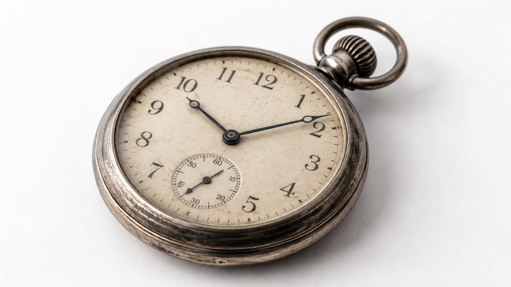 Old vintage pocket watch on white table top 