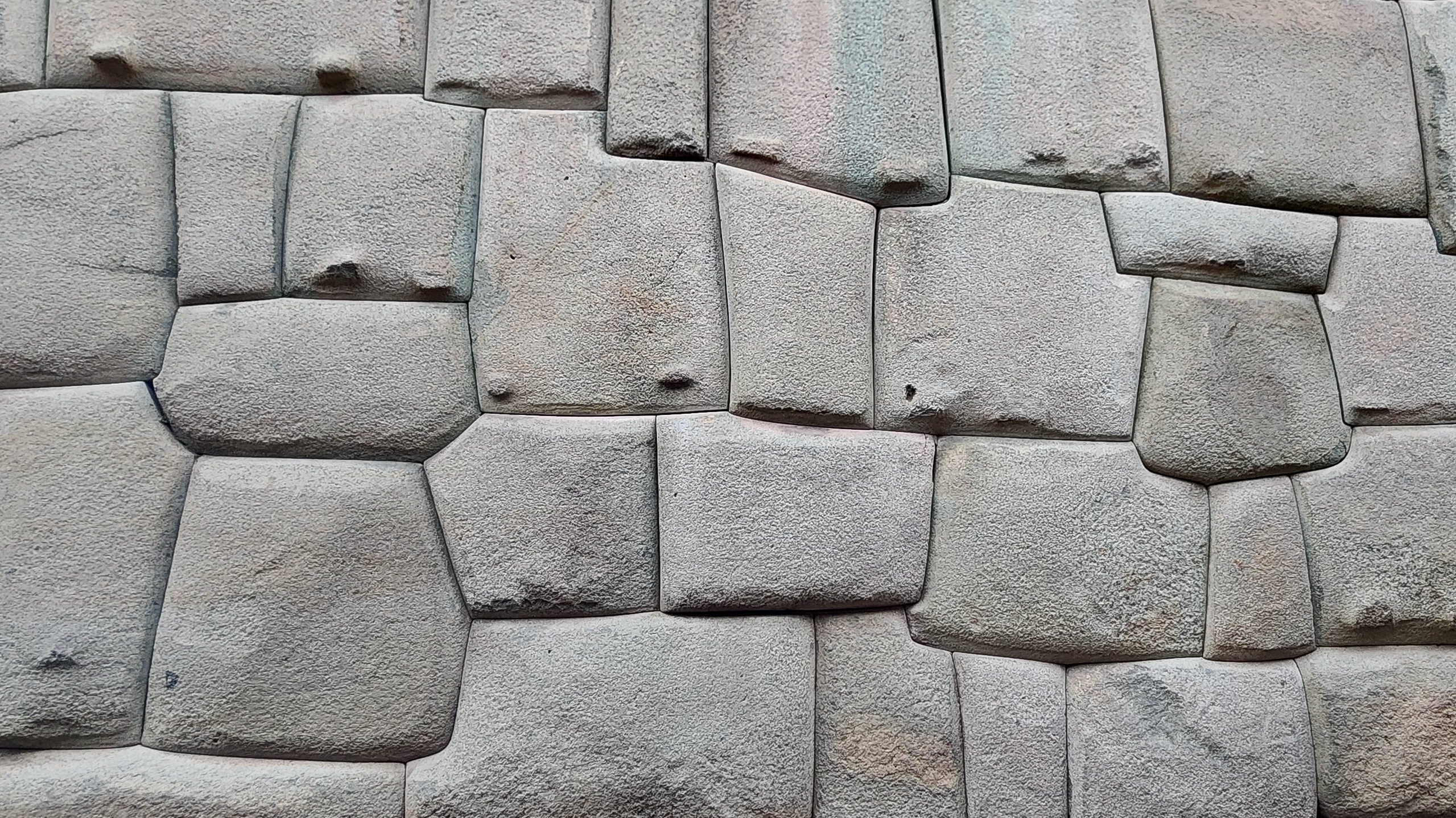 Tightly fitted Inca stone wall, large gray polygonal blocks joined without mortar