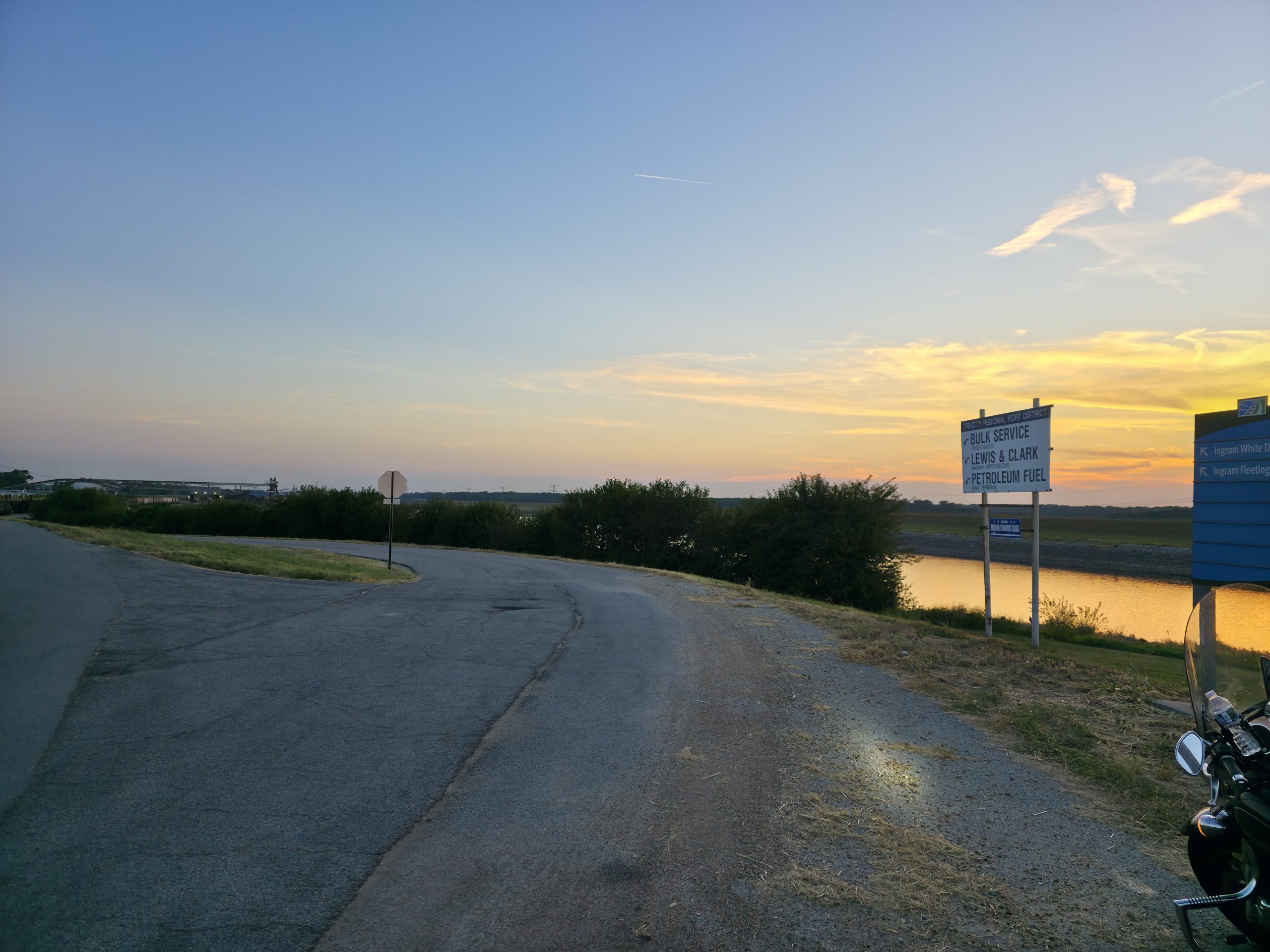 Motorcycle pulled off to the side of the road at sunset — a moment of stillness and the dichotomy of control in practice.